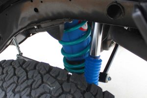 Closeup view of a single Airbag Man airbag, Dobinsons coil spring and Superior remote reservoir shock fitted to the Nissan Patrol