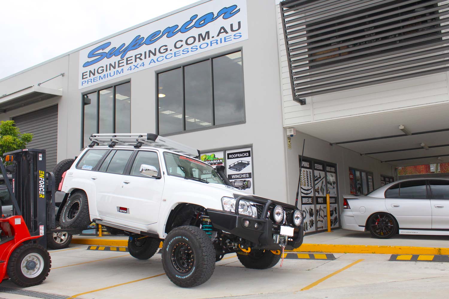Testing out the rear flex of the GU Nissan Patrol wagon with the forklift at the front of the Superior Engineering 4x4 retail showroom at Deception Bay