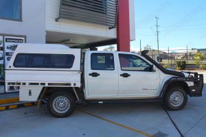Right side view of a white Holden Colorado dual cab fitted with a 40mm Bilstein lift kit and AirBag Man air suspension helper kit for leaf springs