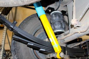 Closeup view of a single heavy duty airbag (fitted between the leaf spring and chassis), Bilstein shock absorber and EFS leaf spring fitted to the Holden Colorado