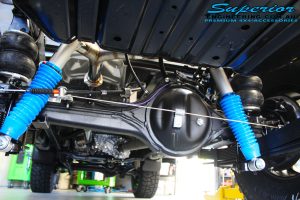 Rear underbody view of the fitted Superior Remote Reservoir Shocks, Leaf Spring and Airbag Man Leaf Air Kit