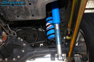 Left underbody inside view of the fitted Superior Nitro Gas Shock + Coil Spring with Airbag Man Coil Air Kit Helper and Lower & Upper Control Arms