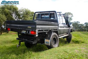 Rear right side view whilst flexing of a Grey Toyota 79 Series Landcruiser Dual Cab after fitment of a Superior 4" Inch Rear Coil Conversion Kit.
