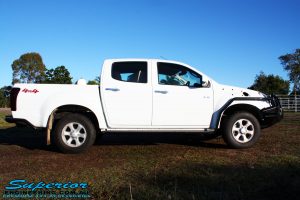 Right side view of a White Isuzu D-Max Dual Cab being fitted with a Superior Remote Reservoir 2" Inch Lift Kit, Airbag Man Leaf Air Kit, Ironman 4x4 Bullbar + Side Steps, VRS Winch, Safari Snorkel + King Wheels & Nitto Tyres