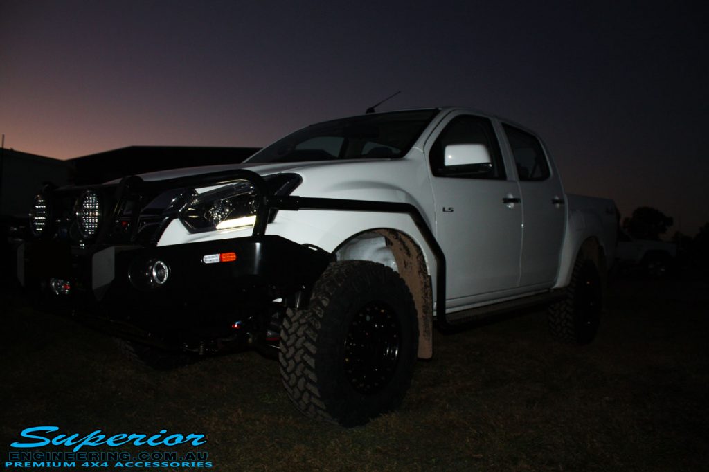 Right front side view of a White Isuzu D-Max Dual Cab after being fitted with a Superior Remote Reservoir 2" Inch Lift Kit, Airbag Man Leaf Air Kit, Ironman 4x4 Bullbar + Side Steps, VRS Winch, Safari Snorkel + King Wheels & Nitto Tyres