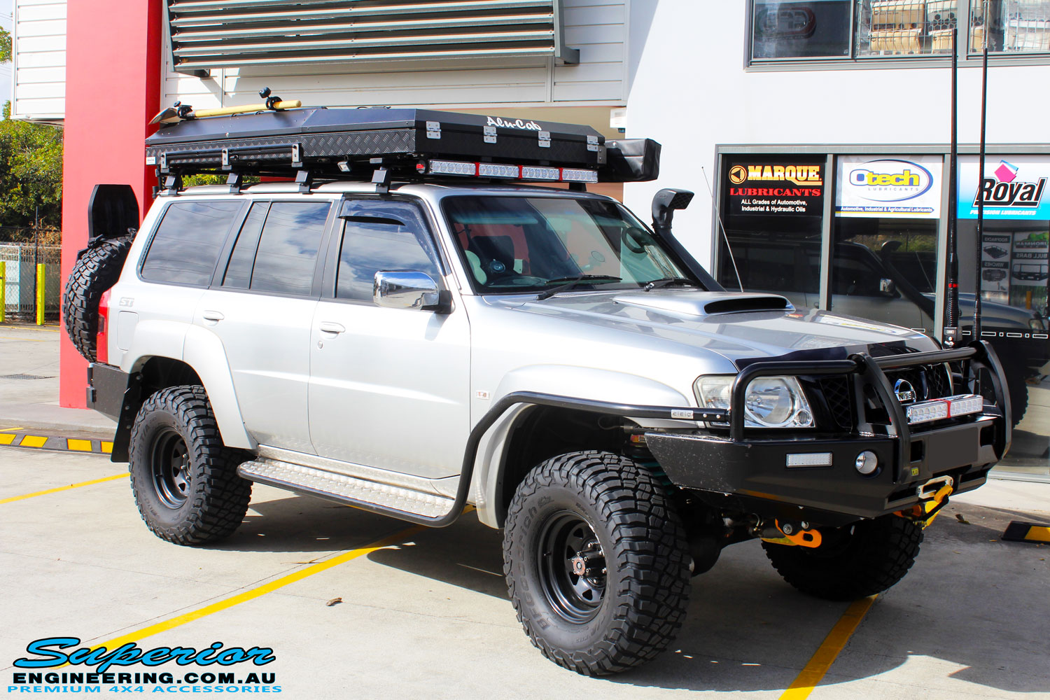 Front right side view of the Nissan GU Patrol Wagon before fitment of a Airbag Man Coil Air Kit & Superior Drop Out Cones