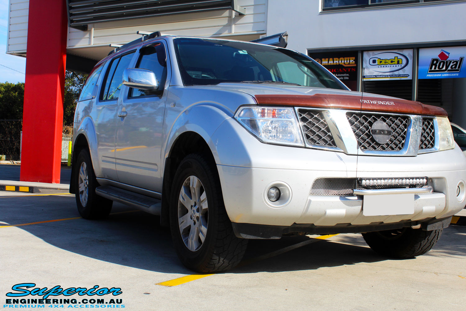 Right front side view of a Nissan R51 Pathfinder in Silver after fitment of a Airbag Man Standard Height Coil Air Kit