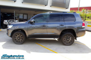 Left side view of a Grey Toyota 200 Series Landcruiser after fitment of a Superior Remote Reservoir 2" Inch Lift Kit with King Springs & Airbag Man 2" Coil Air Helper Kit