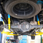 Rear underbody view of the fitted Bilstein Shocks + EFS Leaf Springs and Airbag Man Leaf Air Kit