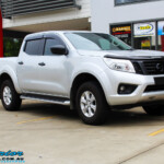 Right front side view of a Grey Nissan NP300 Navara Ute before fitment of a Superior Nitro Gas 4" Inch Lift Kit + Airbag Man 2" Coil Air Kit Helper, Ironman 4x4 Flomax Air Compressor and Nitto Trail Grappler Tyres with King Gator Wheels