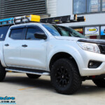 Right front side view of a Grey Nissan NP300 Navara Ute after fitment of a Superior Nitro Gas 4" Inch Lift Kit + Airbag Man 2" Coil Air Kit Helper, Ironman 4x4 Flomax Air Compressor and Nitto Trail Grappler Tyres with King Gator Wheels