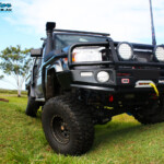 Front on view of a Grey Toyota 79 Series Landcruiser Dual Cab after fitment of a Superior 4" Inch Rear Coil Conversion Kit with Hyperflex Radius Arms.