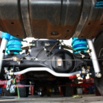 Rear underbody view of the fitted fitted Superior 2" Inch Nitro Gas Shock Absorbers, Coil Springs with Airbag Man Coil Air Kit and Sway Bar Kit