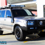 Right front side view of a Silver Toyota 100 Series Landcruiser before fitment of a 2" Inch Lift Kit with Airbags