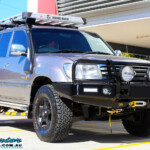 Right front side view of a Silver Toyota 100 Series Landcruiser after fitment of a 2" Inch Lift Kit with Airbags