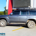 Left side view of a Silver Toyota 100 Series Landcruiser after fitment of a 2" Inch Lift Kit with Airbags