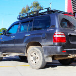 Rear left view of a Silver Toyota 100 Series Landcruiser after fitment of a 2" Inch Lift Kit with Airbags