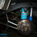 Rear left shot of the fitted Airbag Man Coil Air Helper Kit, Remote Reservoir Shock & Swaybar Kit