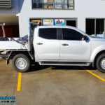 Right side view of a Silver Nissan NP300 Navara Dual Cab before fitment of a Superior Remote Reservoir 2 Inch Lift Kit & Airbag Man Coil Air Kit 2" Inch Lift