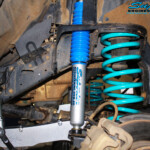 Front right inside guard view of the fitted Superior Nitro Gas 2" Shock + Coil Spring, Swaybar Extension & Hybrid Superflex Radius Arm