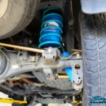 Rear right underbody shot showing the fitted Superior Remote Reservoir Shock Absorber, Coil Spring, Superior Rear Panhard Rod & Airbag Man Coil Air Helper Kit