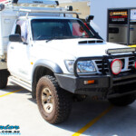 Right front side view of a White Nissan GU Patrol before fitment of a range of Superior and various other brands suspension components