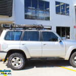 Right side view of a Silver Nissan Patrol GU Wagon before fitting a Superior Remote Reservoir Hybrid Dropped Radius 3" Inch Lift Kit with Hybrid Radius Arms, Steering Damper, Upper & Lower Control Arms, Comp Spec Draglink, Front & Rear Panhard Rods, Superior Coil Tower Brace Kit, Superior Front Steering Radiator Guard, Body Lift and Airbag Man Coil Helper Ait Kit