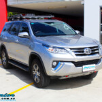 Right front side view of a Toyota Fortuner Wagon in Silver before fitment of a Fox 2.0 Performance Series IFP 2" Inch Lift Kit with Airbag Man Coil Helper Air Kit