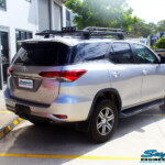 Rear right side view of a Toyota Fortuner Wagon in Silver before fitment of a Fox 2.0 Performance Series IFP 2" Inch Lift Kit with Airbag Man Coil Helper Air Kit